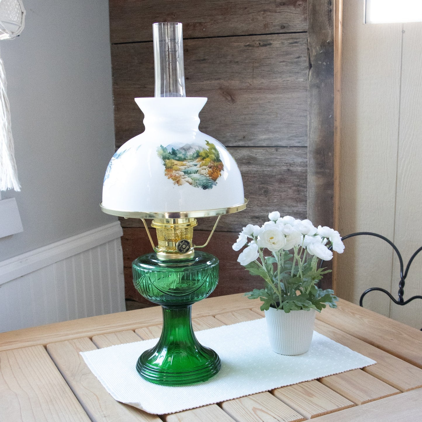 Handcrafted 10-inch white glass lamp shade featuring seasonal mountain stream landscape illustrations, paired with green glass oil lamp base, perfect for Lamps & Lighting, Parts and Accessories, and Lamp Shades collections.