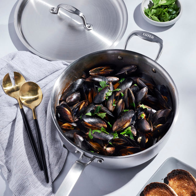 Handcrafted fully clad stainless steel 4-quart saute pan filled with cooked mussels and garnished with fresh herbs, featured in Kitchen & Food, Cookware, and Best Sellers collections.