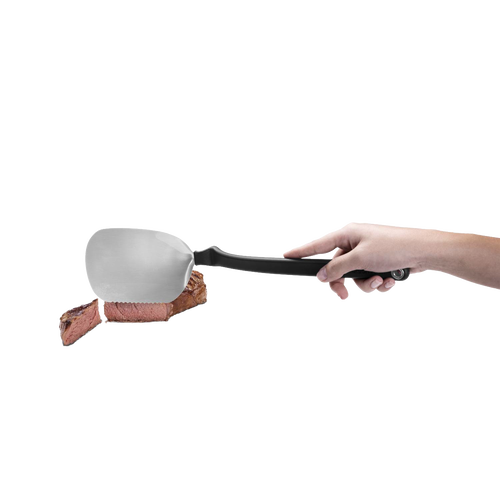 BBQ Chopula stainless steel grill spatula with a black ergonomic handle lifting a sliced piece of steak, suitable for Kitchen & Food, Grilling, and Best Sellers collections.