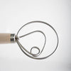 Close-up of a handcrafted Amish made dough whisk with a wooden handle and smooth spiral metal wires, ideal for mixing dough in Kitchen & Food and Baking Supplies collections.
