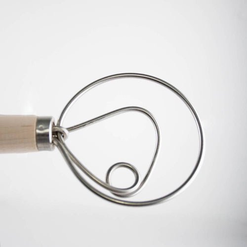 Close-up of a handcrafted Amish made dough whisk with a wooden handle and smooth spiral metal wires, ideal for mixing dough in Kitchen & Food and Baking Supplies collections.