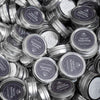 Multiple small metal tins with dark blue labels stacked together, containing handcrafted cast iron seasoning made in the USA, featured in Kitchen & Food, Cookware, and Cast Iron collections.