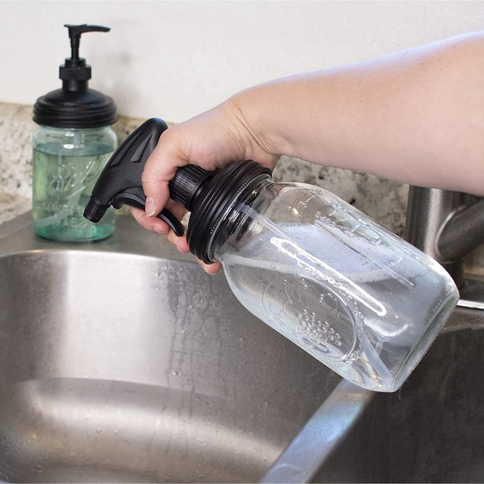 Set of two durable black pump and sprayer lids attached to clear mason jars being used at a kitchen sink, eco-friendly household helpers in Home & Decor, USA Made, and Best Sellers collections.