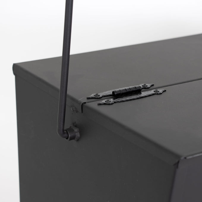 Close-up of a heavy-duty steel ash carrier bucket corner showing a sturdy hinge and handle attachment, ideal for safe ash cleanup in Stoves, USA Made, Hearth Accessories collections.