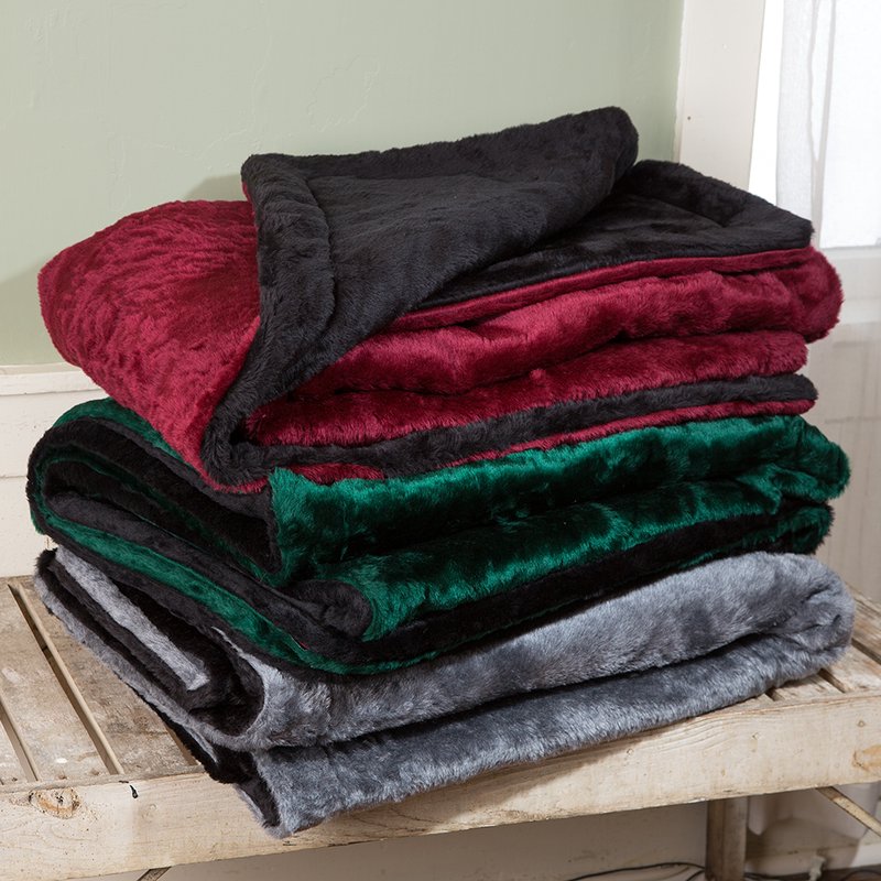 Stacked soft lap robes in deep red, forest green, and gray with plush faux fur exteriors and quilted synthetic linings, handcrafted and Amish made, ideal for Home Textiles and USA Made collections.