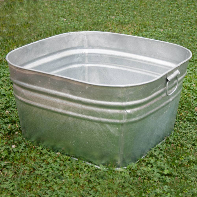 Square galvanized steel wash tub with handles, hot-dipped for durability, set on grass, suitable for indoor and outdoor use in Home & Decor and Laundry Supplies collections.