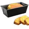 Non-stick heavy gauge steel loaf pan with corrugated sides holding a freshly baked golden bread, accompanied by three thick slices, ideal for Kitchen & Food, Baking Supplies, and Best Sellers collections.
