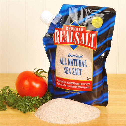 Pouch of natural sea salt with trace minerals, shown alongside fresh tomato and parsley, ideal for Kitchen & Food, Pantry, USA Made, Best Sellers, and Promo Eligible collections.