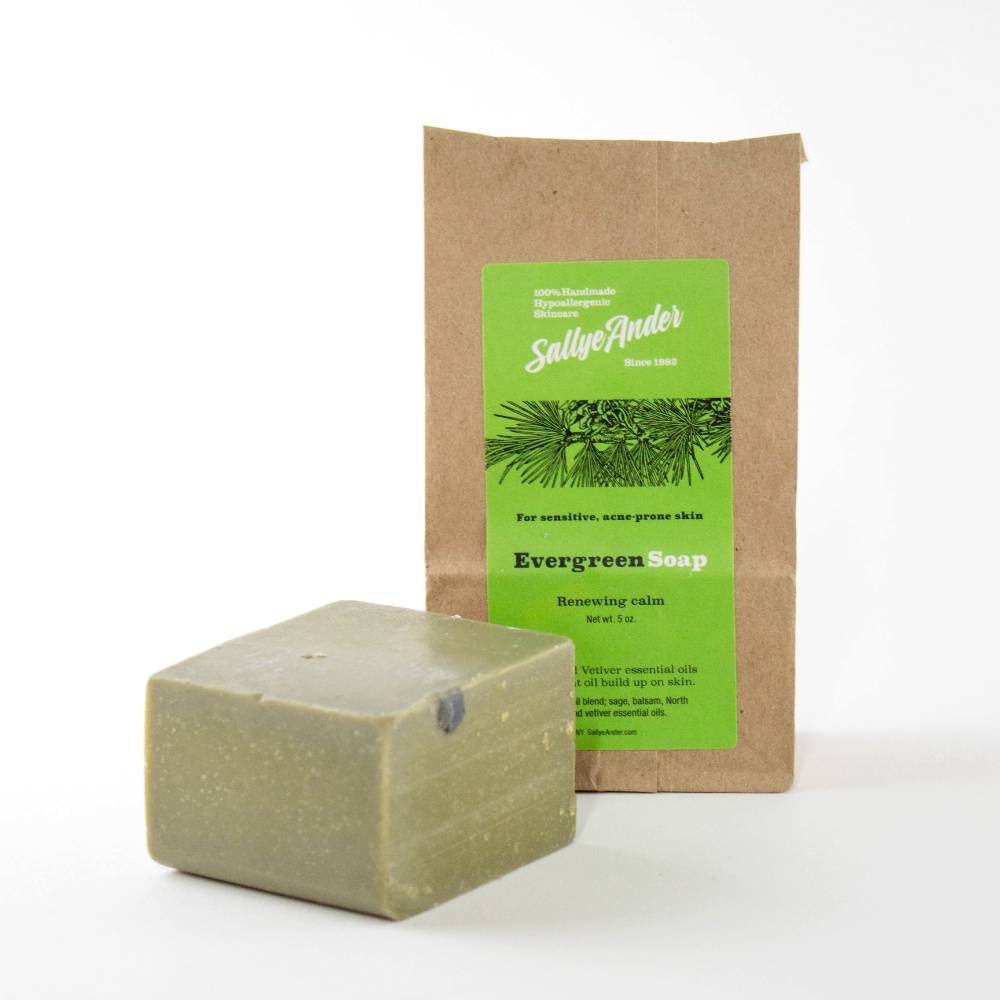 Handcrafted hypoallergenic evergreen soap bar with a smooth green tone, packaged in eco-friendly kraft paper, made in USA for Health & Wellness, Grooming, and Soaps collections.