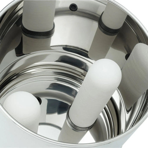 Close-up view inside a polished stainless steel gravity water filter showing four cylindrical ceramic filter elements securely mounted for effective water purification.