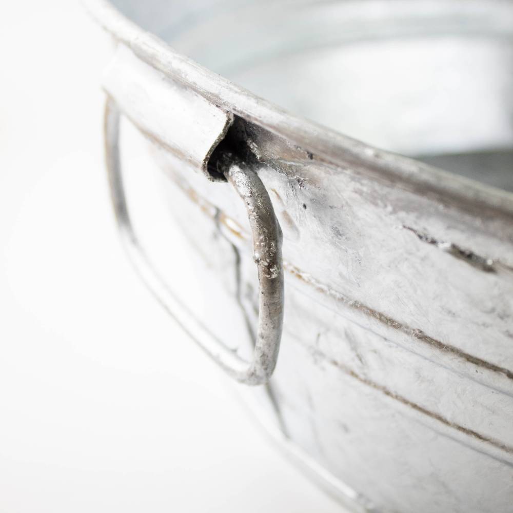 Close-up of a sturdy aged metal wire handle attached to a weather-resistant low flat steel tub handcrafted for versatile use in Home & Decor, Farm, Garden & Tool, Animal Care, and Household Helpers collections.
