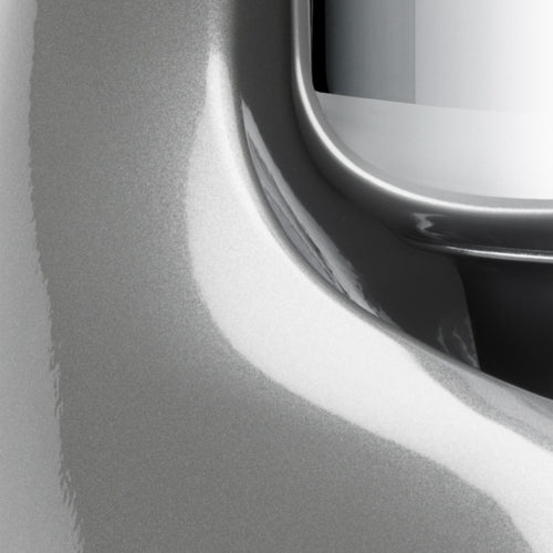 Close-up of a glossy silver-gray handcrafted stand mixer base with smooth curves and part of a polished stainless steel bowl, ideal for Kitchen & Food, Baking Supplies, and Cooking and Baking Helpers collections.