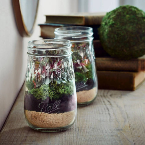 Pair of handcrafted USA-made regular-mouth pint canning jars with embossed diamond design, used for food preservation and attractive storage in kitchen and canning collections.