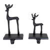 Set of two handcrafted black iron deer stocking holders in large and small sizes, designed for sturdy and charming holiday mantel display, perfect for Home & Decor and Holiday Decor collections.