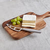 Stainless steel soft cheese knife with vented blade and forked tip resting on a wooden cutting board beside sliced brie and green grapes, ideal for Kitchen & Food and Food Prep collections.