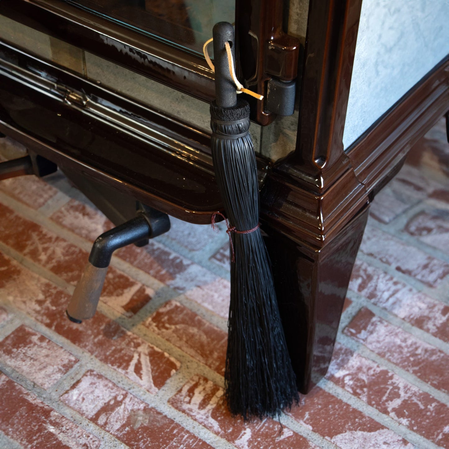 Handcrafted Amish made small hand broom with black straw bristles and wooden handle, designed for cleaning fireplaces and wood stoves, featured in Hearth Accessories and USA Made collections.