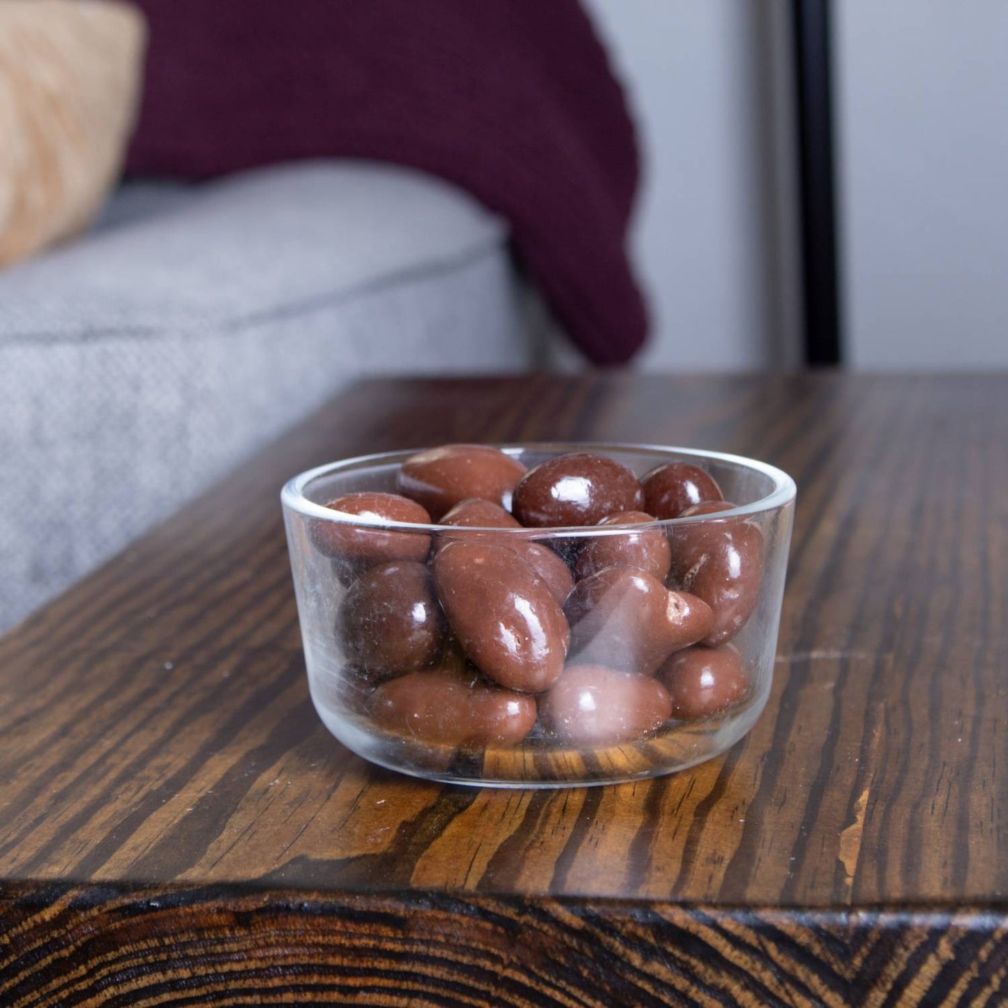 Clear glass bowl filled with glossy milk chocolate coated nuts including cashews, almonds, pecans, and Brazil nuts, handcrafted and made in USA, ideal for Kitchen & Food, Snacks and Sweets, Candy, USA Made, Best Sellers collections.