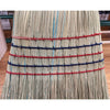 Close-up of a handcrafted large corn broom with tightly bound natural corn straw bristles featuring red and blue stitching, Amish made in the USA for farm, garden, and household cleaning.