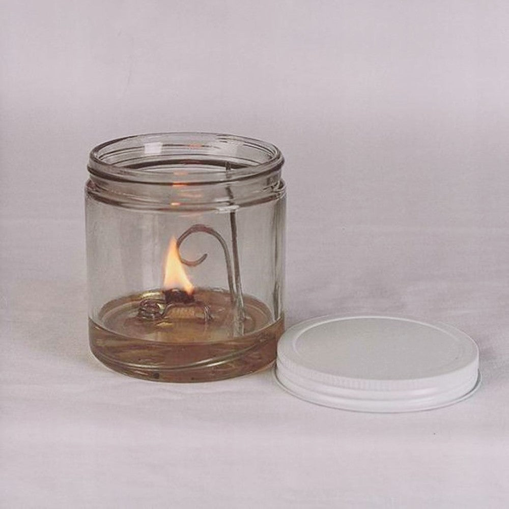 Handcrafted Merry Corliss Cabin olive oil lamp with a wide flat wick burning in a clear glass jar, made in USA, featured in Lamps & Lighting, Olive Oil Lamps, and Best Sellers collections.