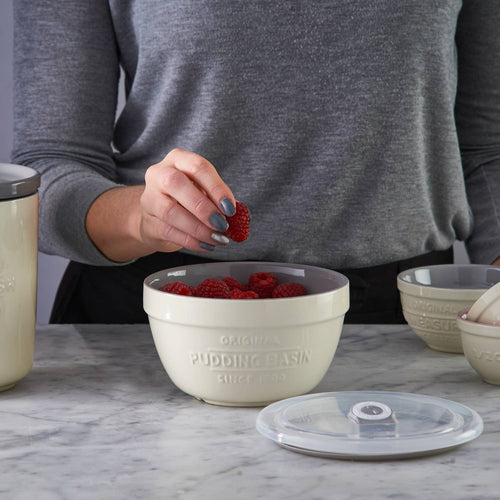 Cream-colored Mason Cash all-purpose bowl with embossed pudding basin text, filled with fresh raspberries, accompanied by a clear airtight lid, ideal for Kitchen & Food, Cookware, Baking Supplies, Storage and Serving, Best Sellers, and Promo Eligible collections.