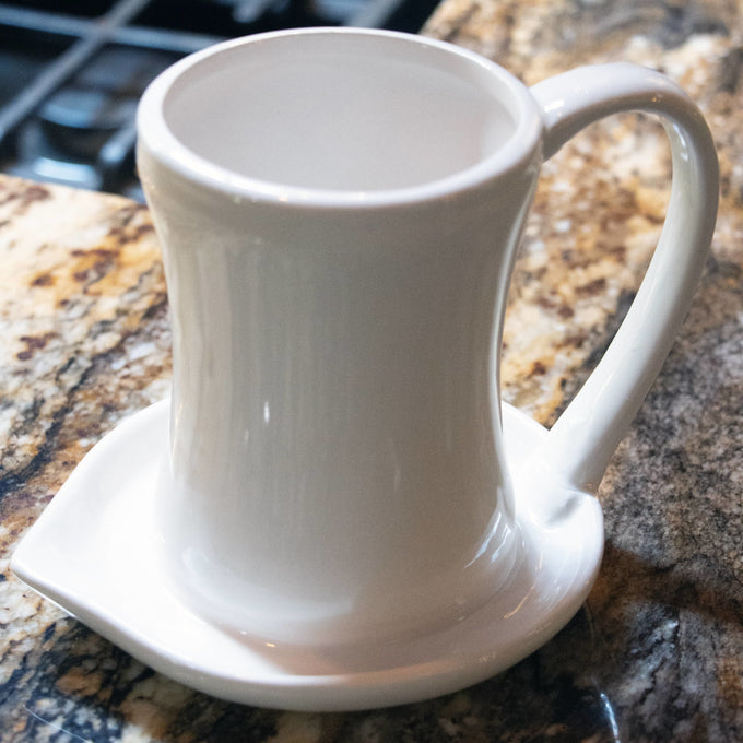 Cream-colored ceramic bacon cooker with a handle and wide base designed to catch grease, handcrafted for easy microwave use and featured in Kitchen & Food, Kitchen Gadgets, and Cooking and Baking Helpers collections.