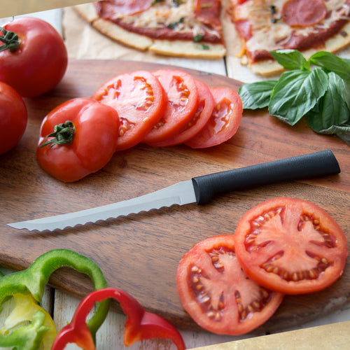 Handcrafted Rada Tomato Slicer with hand-sharpened high carbon surgical stainless steel serrated blade and smooth black handle on wooden cutting board, slicing fresh tomatoes, USA Made, ideal for Kitchen & Food and Farm, Garden & Tool collections.