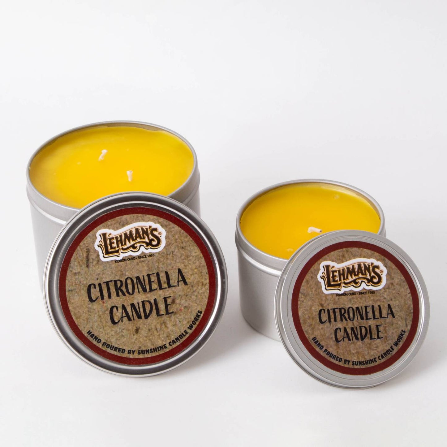 Two handcrafted citronella candles with bright yellow wax in lightweight metal tins, featuring branded lids, designed for outdoor use in camping, pest control, and garden lighting collections.