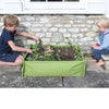 Two children engaged with a green fabric raised garden bed containing young plants and flowers, perfect for introducing gardening in Farm, Garden & Tool, Children's Toys, and Outdoor Play collections.