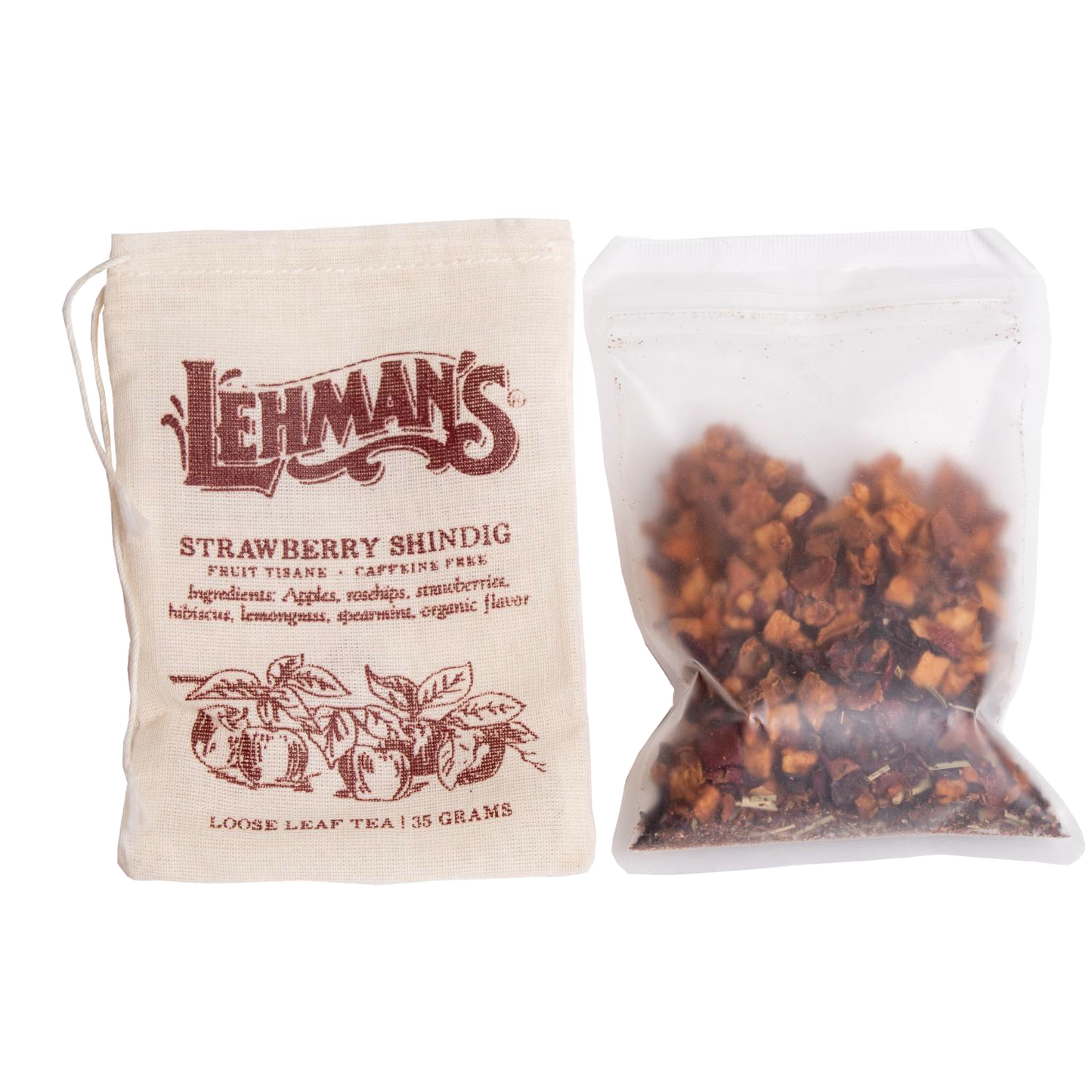 Natural beige drawstring bag labeled Lehman’s Strawberry Shindig loose leaf fruit tisane next to a clear pouch of dried tea ingredients, a handcrafted USA made beverage from Kitchen & Food and Beverages collections.