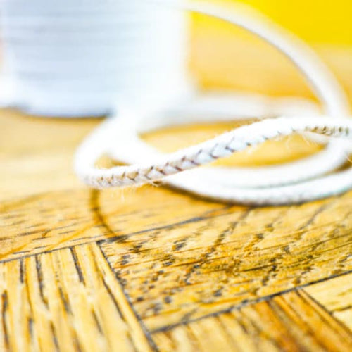Close-up of durable 30-ply flat-braided cotton wicking designed for pillar or taper candles from 2 to 4 inches, featured in Lamps & Lighting, Candles and Candlemaking, and Best Sellers collections.
