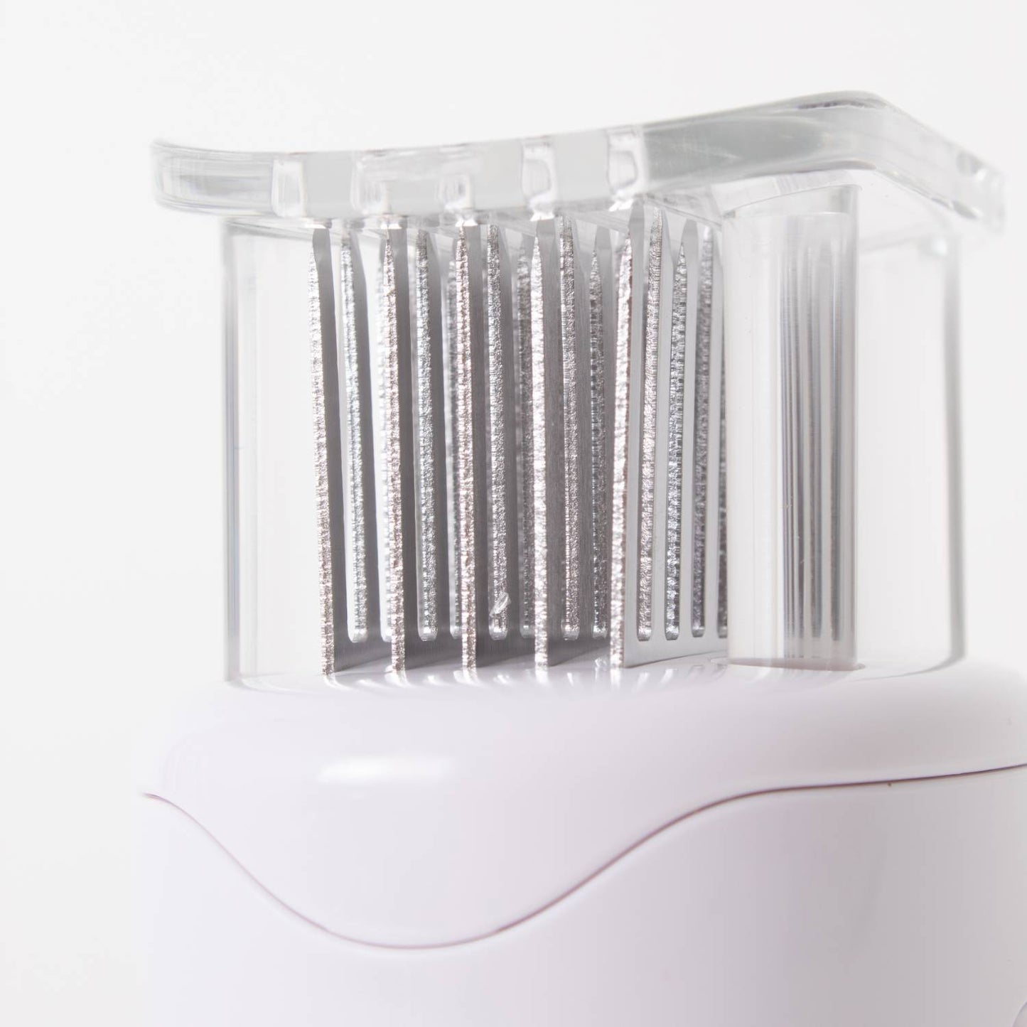 Close-up of stainless steel blades with a transparent protective cover on a white meat tenderizer featuring a non-slip grip, part of Kitchen & Food, Specialty Equipment, Butchering Supplies, and Best Sellers collections.