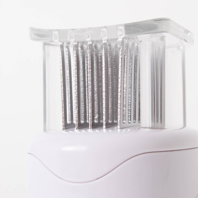 Close-up of stainless steel blades with a transparent protective cover on a white meat tenderizer featuring a non-slip grip, part of Kitchen & Food, Specialty Equipment, Butchering Supplies, and Best Sellers collections.