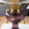Close-up of an amethyst and clear glass oil lamp base with brass burner, handcrafted and bright for reading, ideal for Farm, Garden & Tool, Lamps & Lighting, Emergency Supplies, Oil Lamps, Table Lamps, Best Sellers, and Promo Eligible collections.