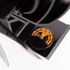 Close-up of a temperature gauge on a handcrafted rotating stove fan featuring a black metal frame and orange dial, part of hearth accessories and stove collections.
