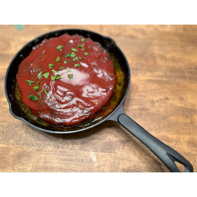 Handcrafted nitrogen-infused cast iron skillet cooking a savory dish topped with rich tomato sauce and fresh herbs, featured in Kitchen & Food, Cookware, Cast Iron, Best Sellers, and Promo Eligible collections.