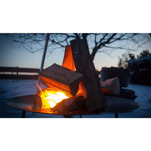 Round steel fire bowl with sturdy legs holding burning firewood, creating a warm outdoor ambiance at dusk, ideal for Farm, Garden & Tool, Camping, Best Sellers, and Promo Eligible collections.