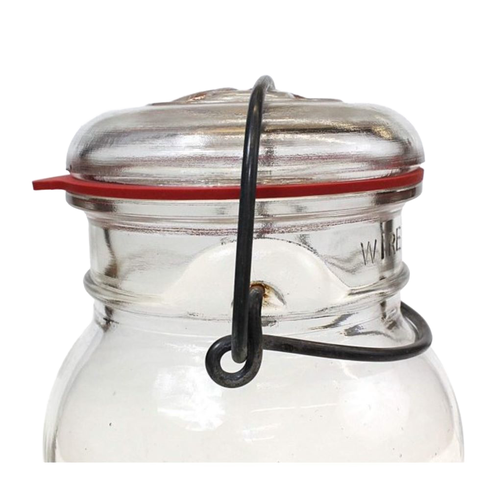 Close-up of a glass jar sealed with a wire clamp lid featuring a handcrafted red natural rubber gasket, ideal for Kitchen & Food, Food Preservation, and Canning collections.