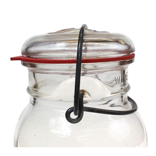 Close-up of a glass jar sealed with a wire clamp lid featuring a handcrafted red natural rubber gasket, ideal for Kitchen & Food, Food Preservation, and Canning collections.