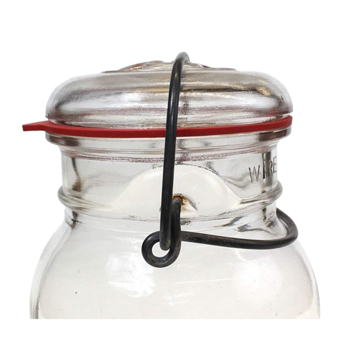 Close-up of a glass jar sealed with a wire clamp lid featuring a handcrafted red natural rubber gasket, ideal for Kitchen & Food, Food Preservation, and Canning collections.