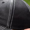 Close-up of a handcrafted adjustable hat featuring a weathered cotton front panel, black breathable mesh back, and detailed white stitching, ideal for Health & Wellness, Clothing and Accessories, Best Sellers, and Promo Eligible collections.