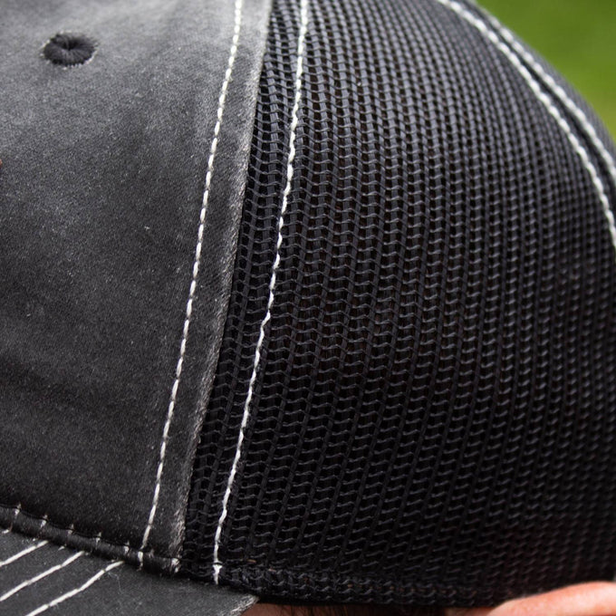 Close-up of a handcrafted adjustable hat featuring a weathered cotton front panel, black breathable mesh back, and detailed white stitching, ideal for Health & Wellness, Clothing and Accessories, Best Sellers, and Promo Eligible collections.