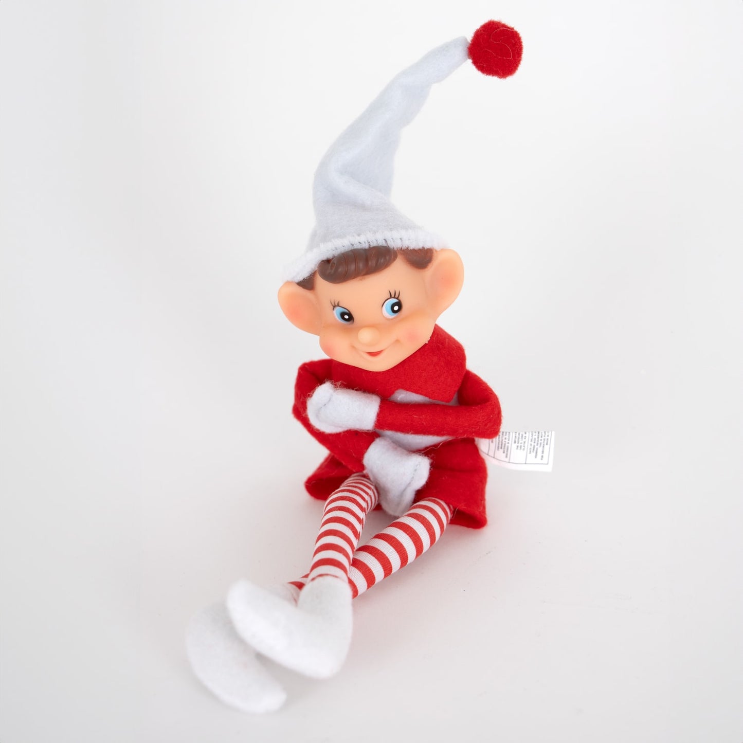 Posable vintage-style pixie elf ornament with fabric body, red and white striped legs, and a tall white hat with red pom, perfect for Home & Decor and Holiday Decor collections.