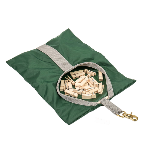 Green fabric clothespin bag with beige strap and brass clip, filled with wooden clothespins, handcrafted and Amish made, perfect for laundry and clothesline accessories.