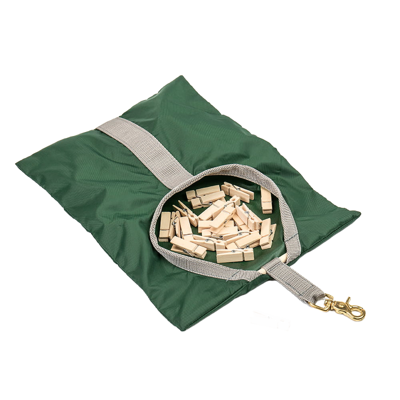 Green fabric clothespin bag with beige strap and brass clip, filled with wooden clothespins, handcrafted and Amish made, perfect for laundry and clothesline accessories.