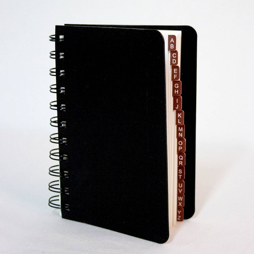 Spiral-bound black logbook with alphabetical tab dividers for organizing internet passwords and website information, ideal for Home & Decor and Household Helpers collections.