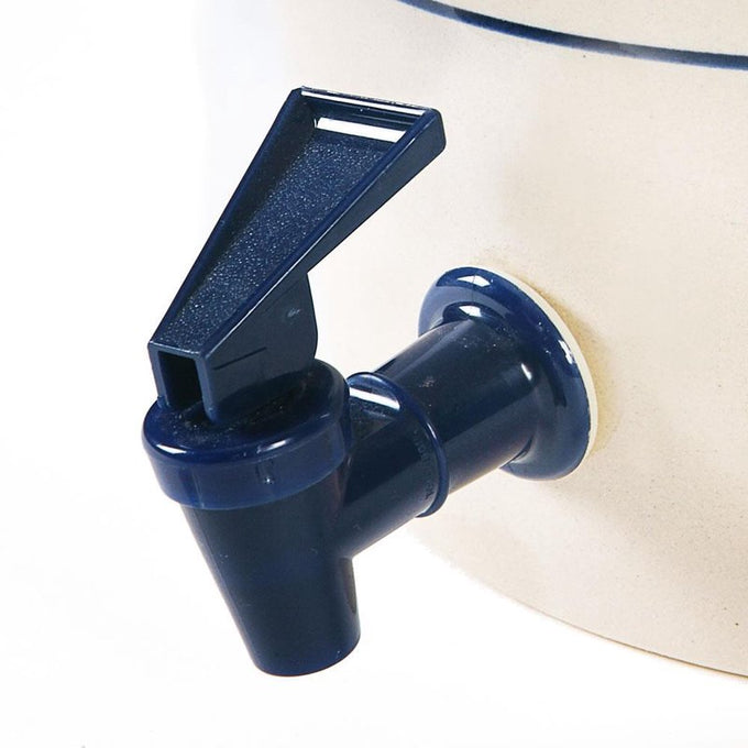 Close-up of a handcrafted stoneware water cooler spigot in deep blue, part of USA made kitchen and food storage and serving collection, best sellers and promo eligible.