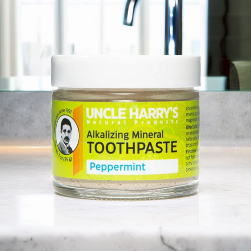 Small handcrafted glass jar of peppermint alkalizing mineral toothpaste in a clear container with white lid and bright yellow label, featured in Health & Wellness, Grooming and Personal Hygiene, USA Made, and Best Sellers collections.