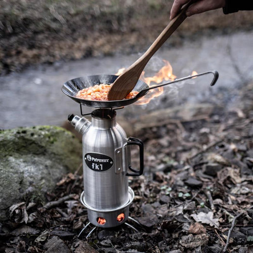 Compact outdoor cooking setup with a sturdy pan heating a meal over a portable stove in a natural forest setting, perfect for camping and Farm, Garden & Tool, Kitchen & Food collections.