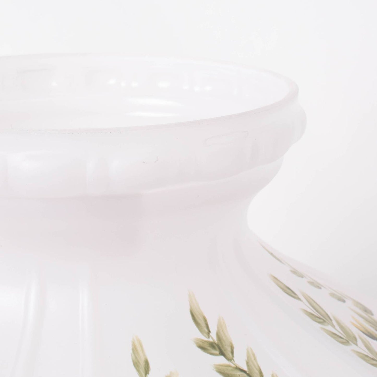Handcrafted glass lamp shade in soft white with subtle green leaf accents, designed to gently diffuse light from oil lamps, featured in Lamps & Lighting and Best Sellers collections.