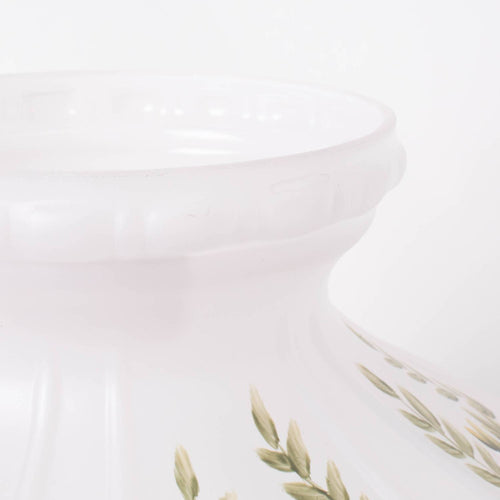 Handcrafted glass lamp shade in soft white with subtle green leaf accents, designed to gently diffuse light from oil lamps, featured in Lamps & Lighting and Best Sellers collections.
